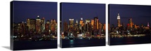 Skyscrapers lit up at night in a city, Manhattan, New York City, New York State