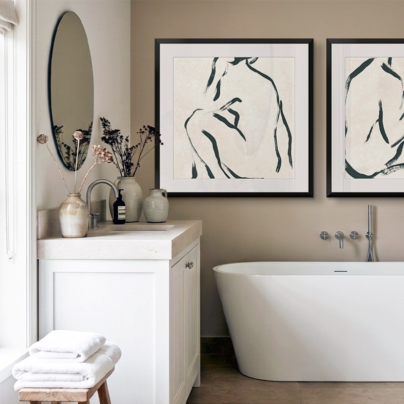 framed print of a minimalist outline of a woman hanging in a bathroom