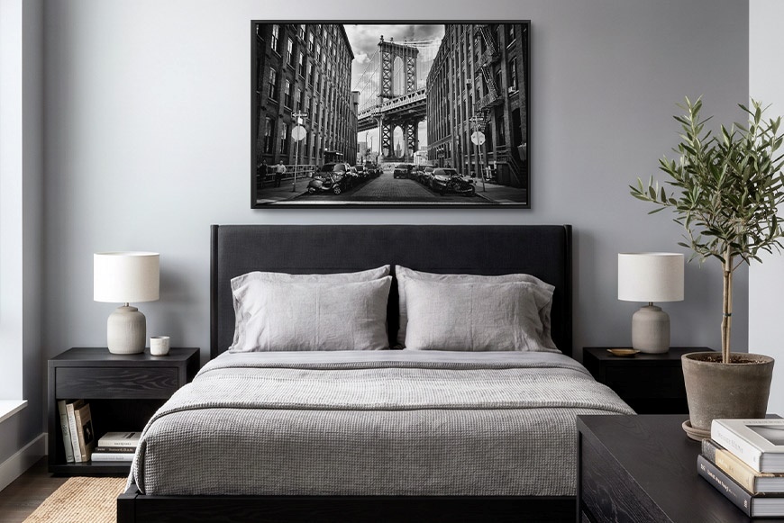 Framed canvas print of New York City hanging in a bedroom