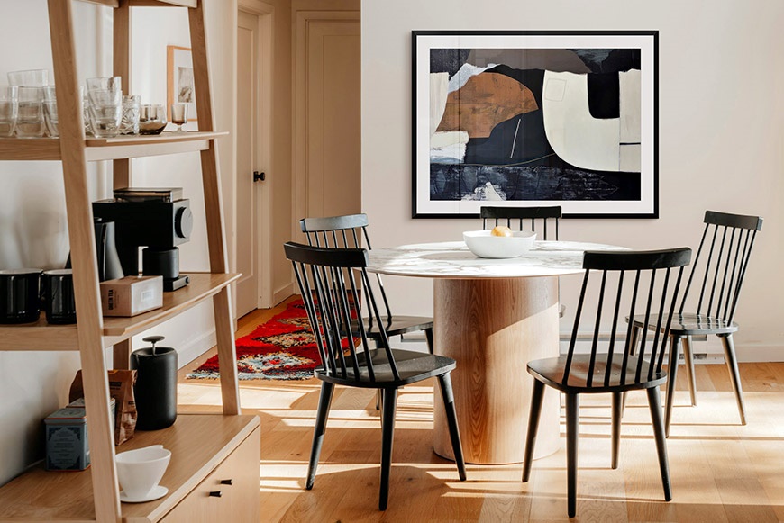 Abstract framed print art hanging in a dining room