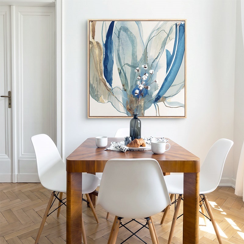 floating frame canvas print of an abstract flower in a bright dining room