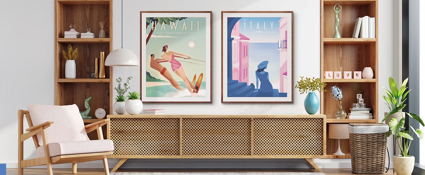 two framed prints of travel poster art in a bright entryway