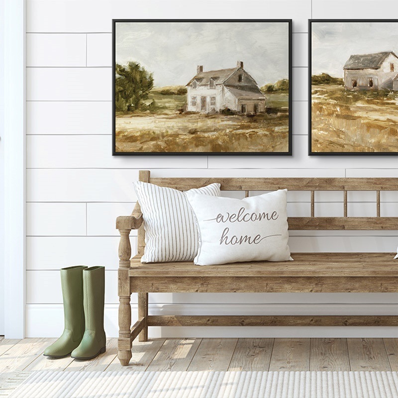Two framed canvas prints of soft farmhouse paintings in a farmhouse styled mudroom
