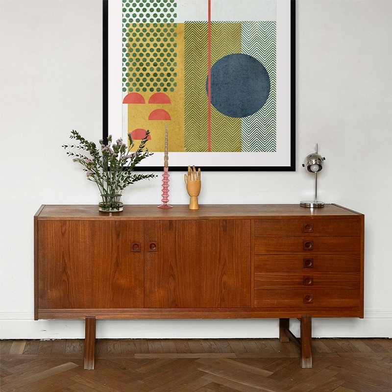 Framed print of mid-century abstract in a styled entryway