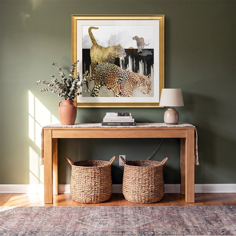 Framed print of metallic leopards in a boho entryway