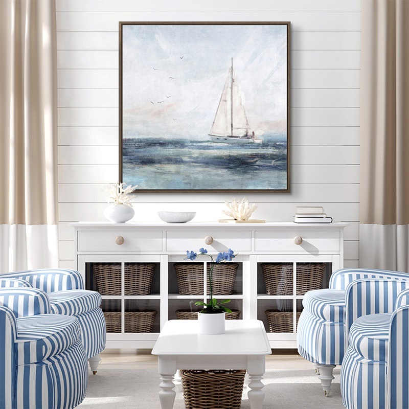 framed canvas print of a sailboat in a coastal entryway