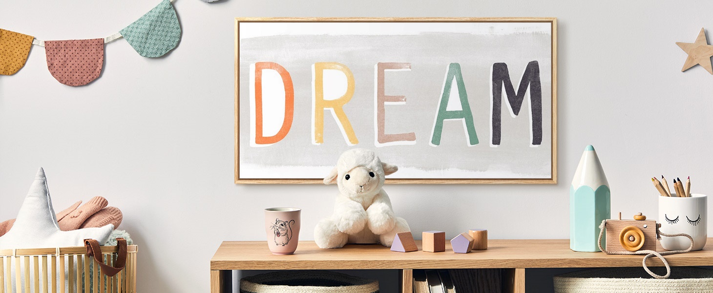 framed canvas print of the word 'DREAM' in a nursery