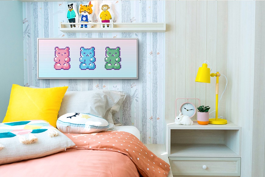 colorful art print of gummy bears in a floating frame hanging in a girl's bedroom