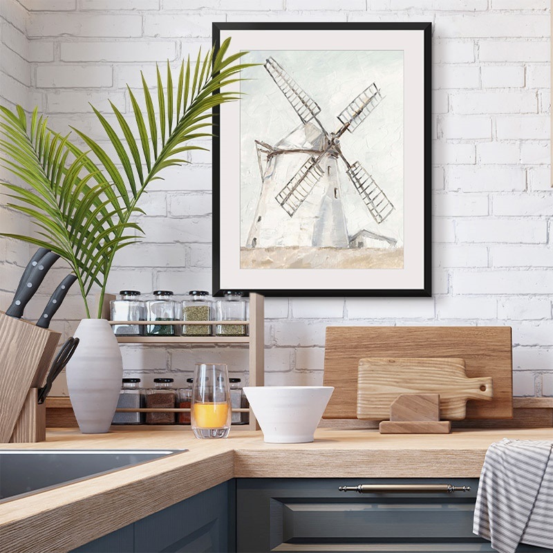 Framed print of a watercolor painting of a windmill in a farmhouse kitchen