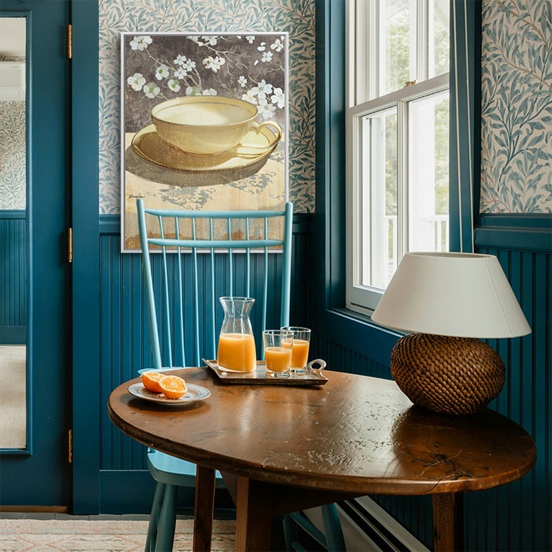 Floating framed print of a painting of a teacup in a bright kitchen