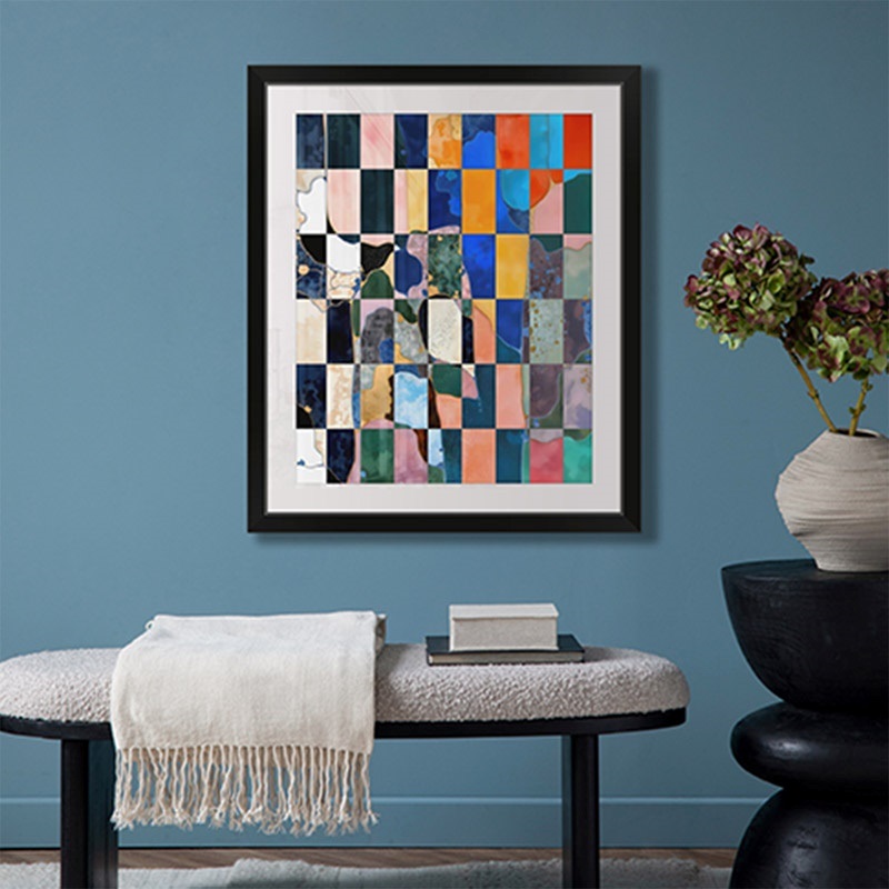 an abstract piece of art hanging above a bench