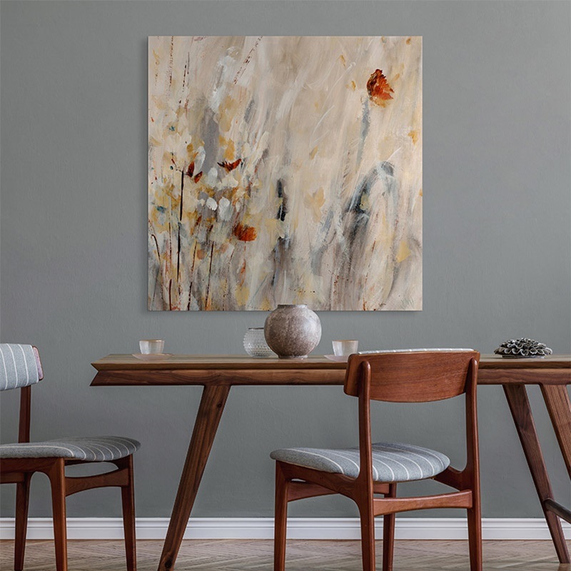 an abstract floral painting on canvas hanging above a dining table