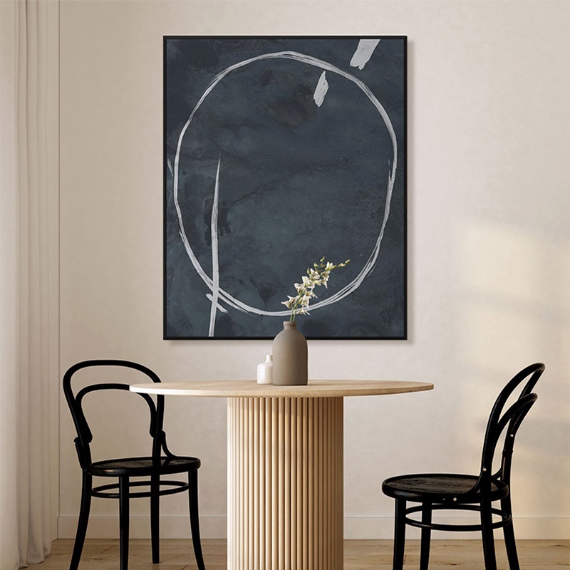 an abstract hanging above a dining table