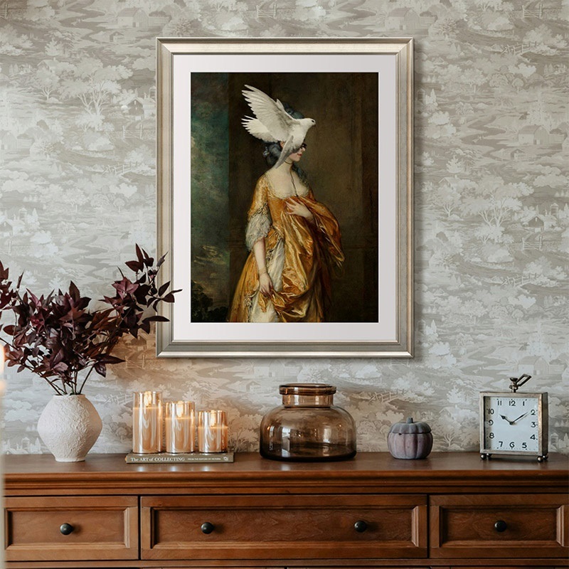 a portrait of an elegant woman with a bird in flight near her head hanging above a console table