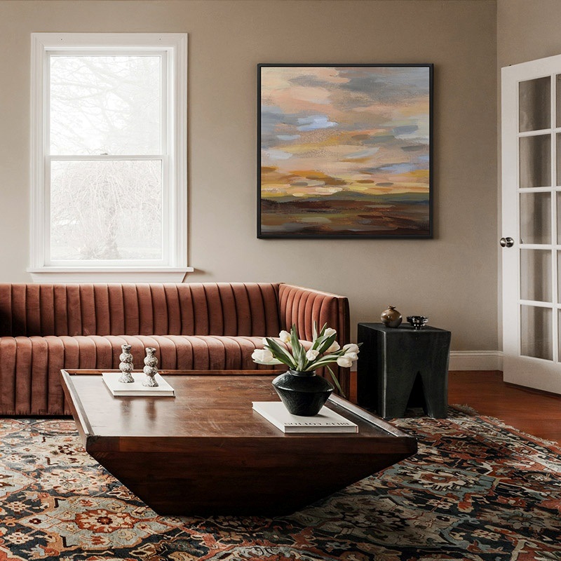 framed canvas print of an abstract landscape at sunset in a living room
