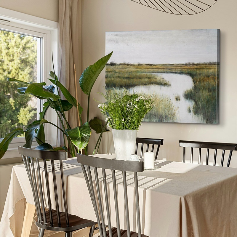 canvas art print of a stark landscape painting in a bright dining room