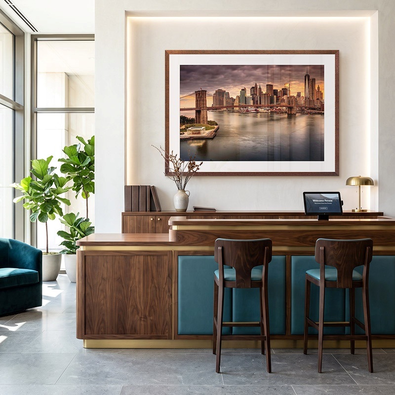 Framed print of a cityscape photograph in a modern hotel lobby