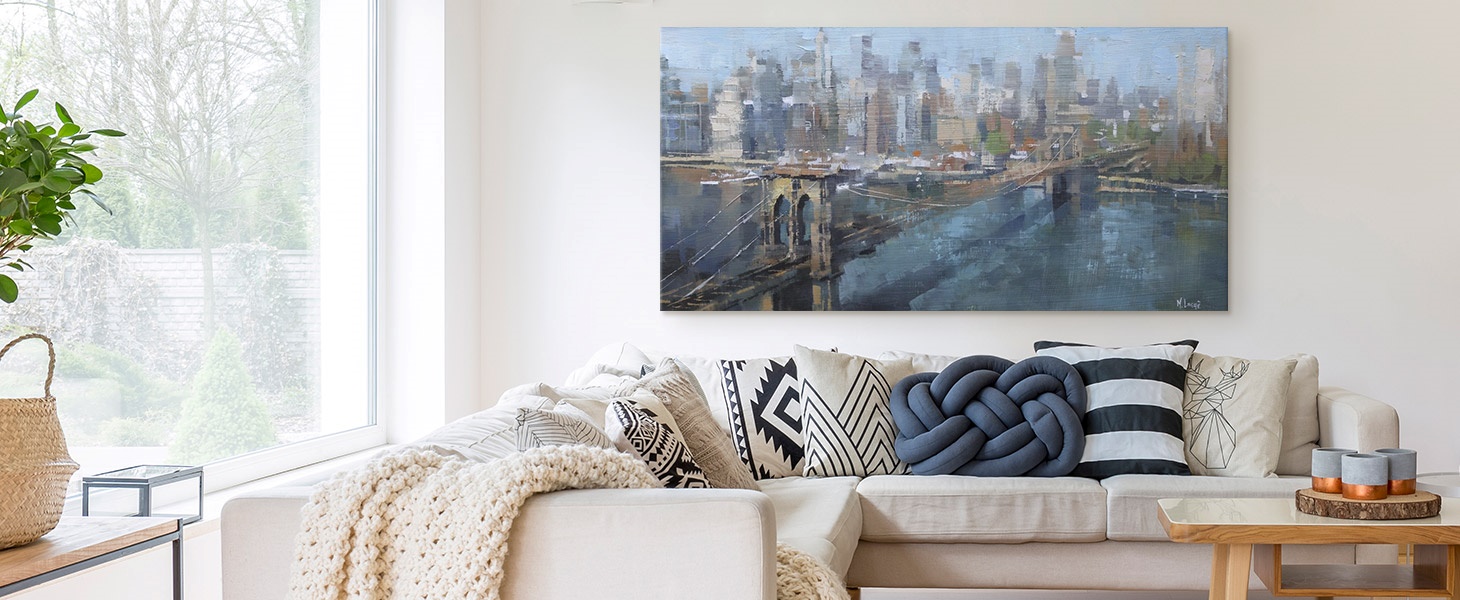 Canvas print of a painting of a city skyline hanging over a couch