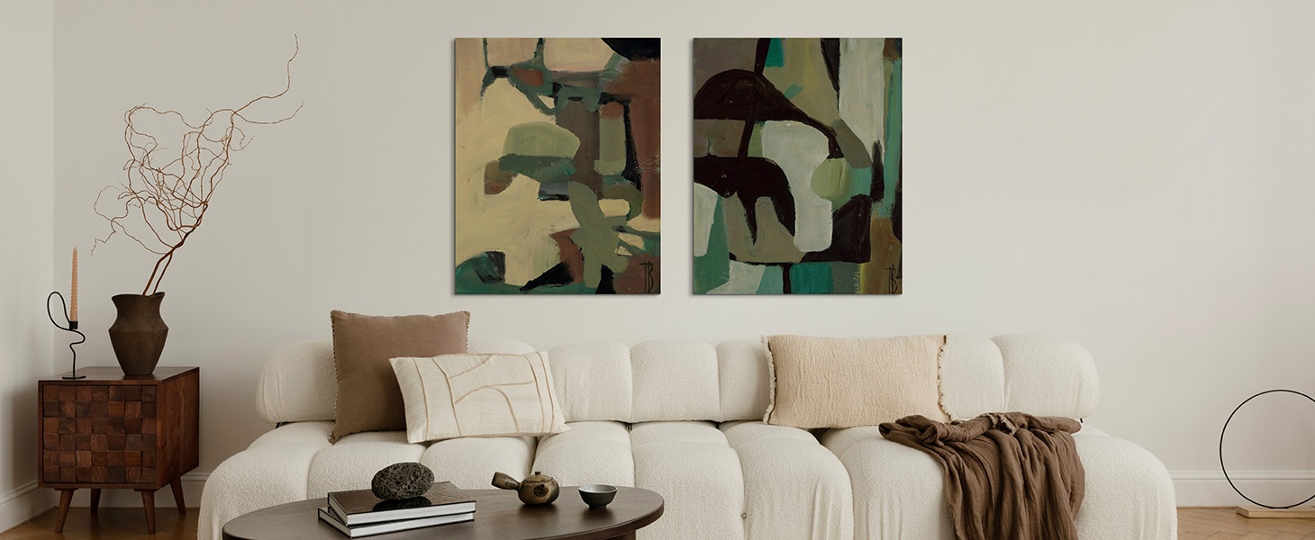 two canvas art pieces of abstracts hanging above a couch