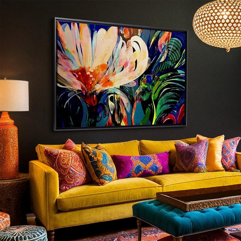 framed canvas hanging above a sofa in an eclectic living room