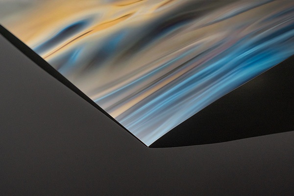 a close up view of the corner of colorful art printed on poster paper