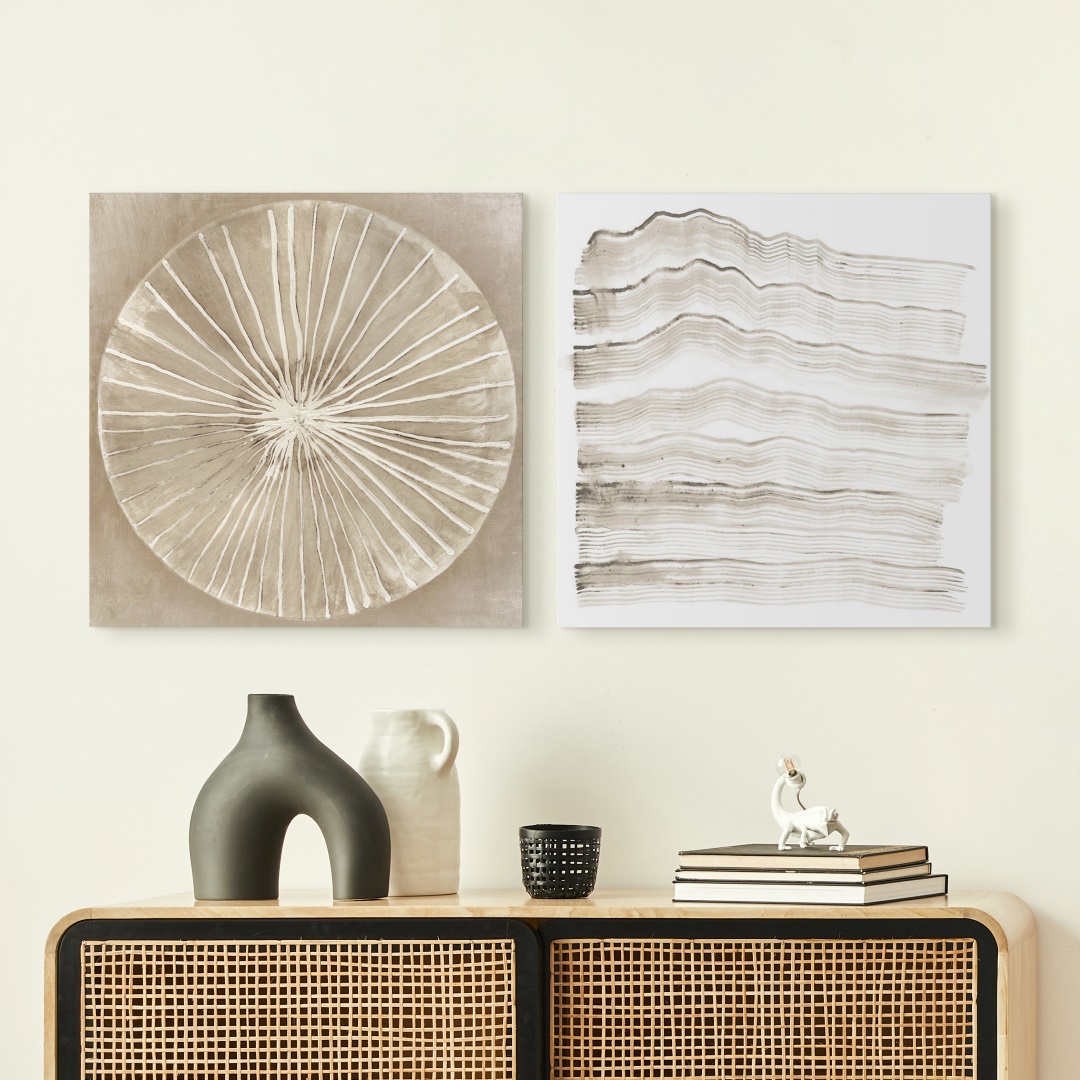 two soft neutral abstract canvases in a bohemian entryway