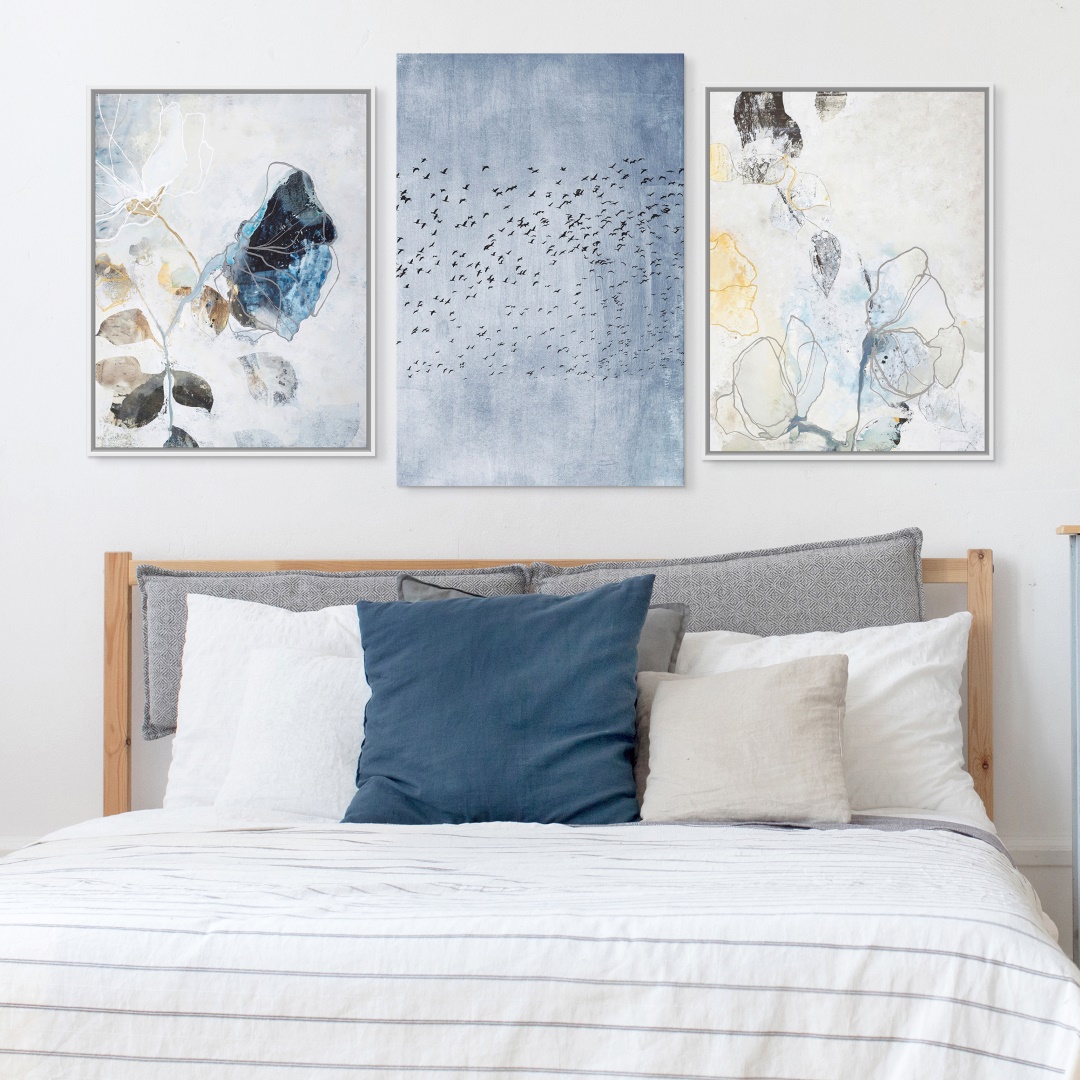 a three piece set of soft floral abstract art prints in a Scandinavian bedroom