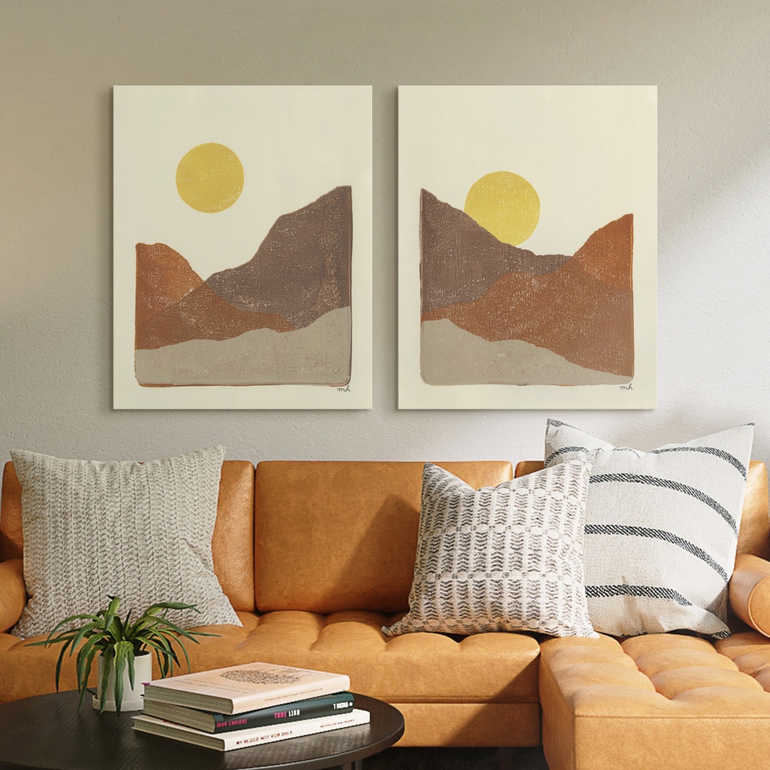 two neutral desert canvas art prints hanging over a bohemian couch