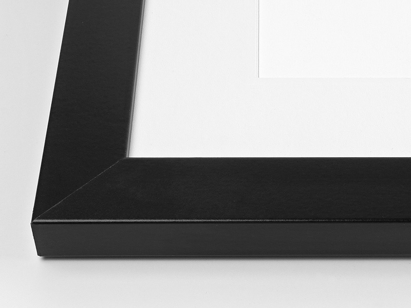 Close-up view of the corner of an art print with a black frame
