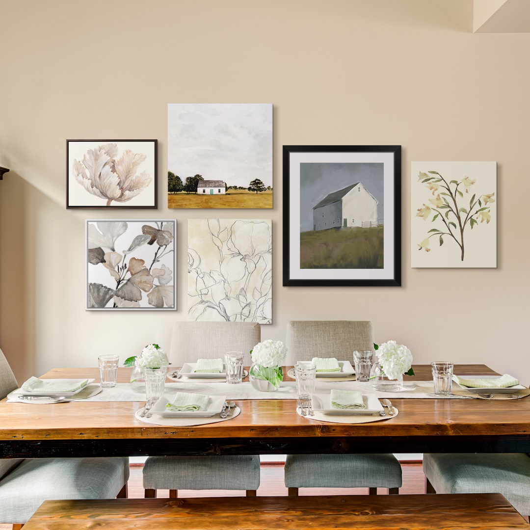Eclectic mix of framed wall art prints on a dining room wall