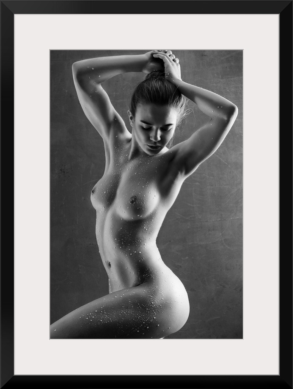Elegant black and white fine art photograph of a nude woman posing with water drops all over her body.