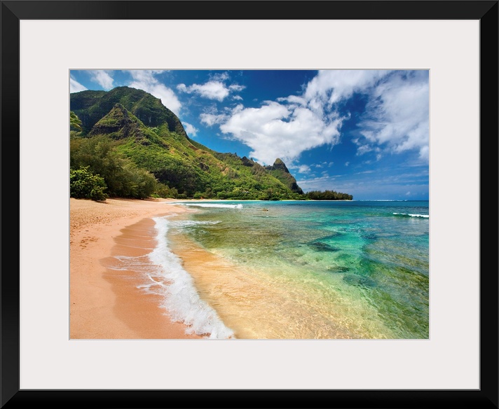 Big photograph shows the clear waters of the Pacific Ocean slowly making their way to the sandy shores of an island.  In t...