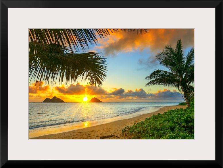 Sunrise viewed from Lanikai Beach with a view of the Mokulua Islands off the coast; Oahu, Hawaii, United States of America.