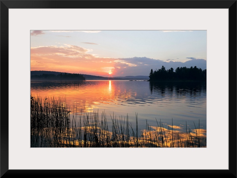 Canvas print of a peaceful lake with a sunset reflected onto it.