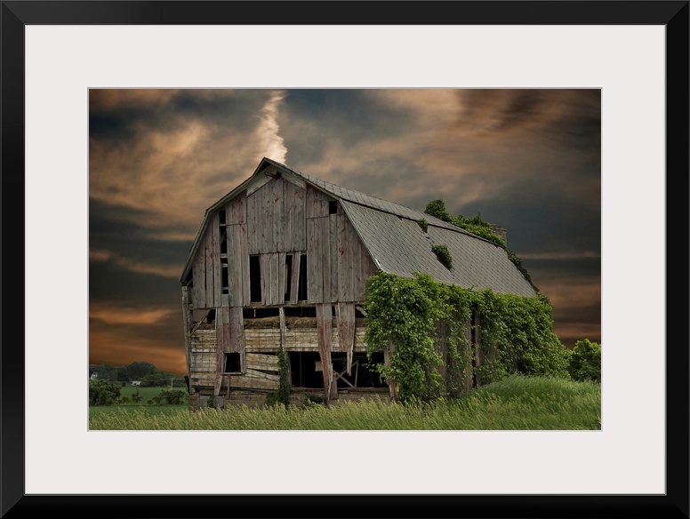 Dilapidated old barn with sunset sky.