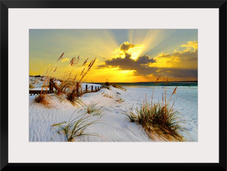 Landscape photograph of a golden beach sunset along a beautiful coast. This golden sunset has magnificent golden light bre...