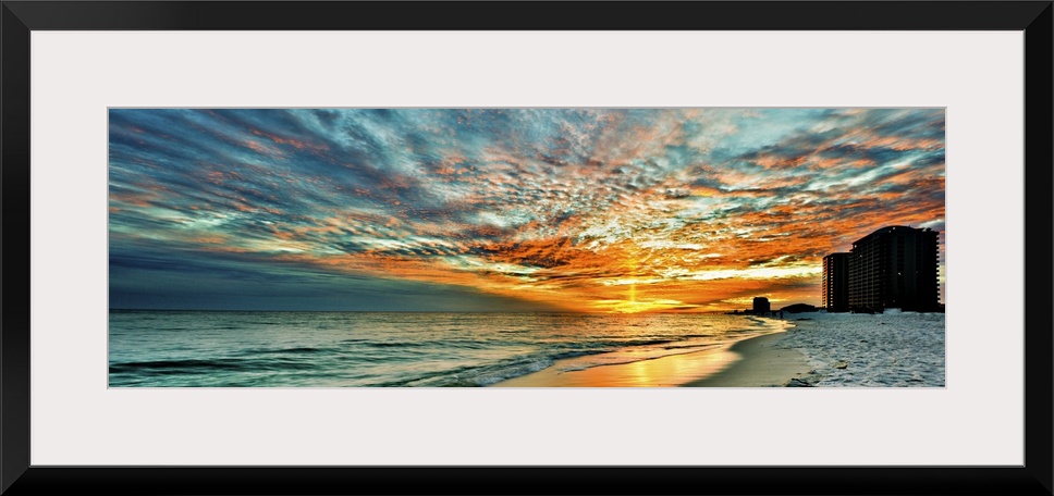 A magnificent red skyscape in this panoramic sunset. Landscape taken on Navarre Beach, Florida.