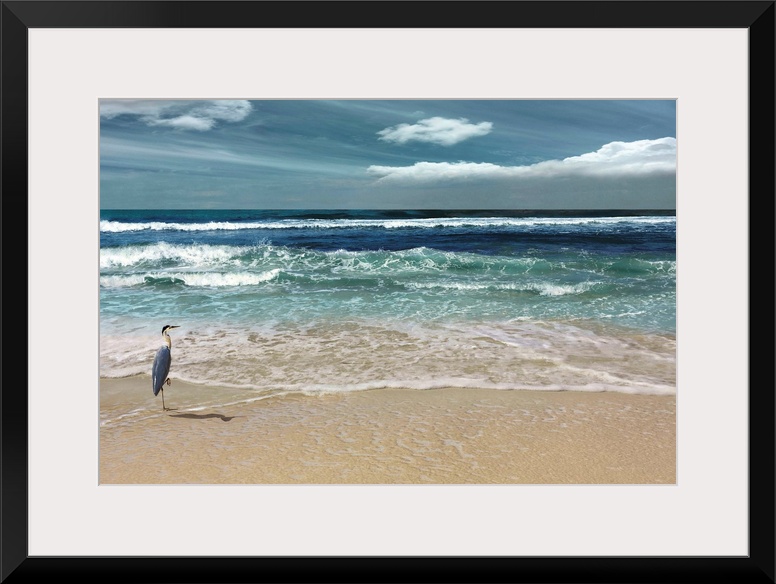 This serene photo shows rippling waves as they approach the heron on the beach with white clouds in the background.