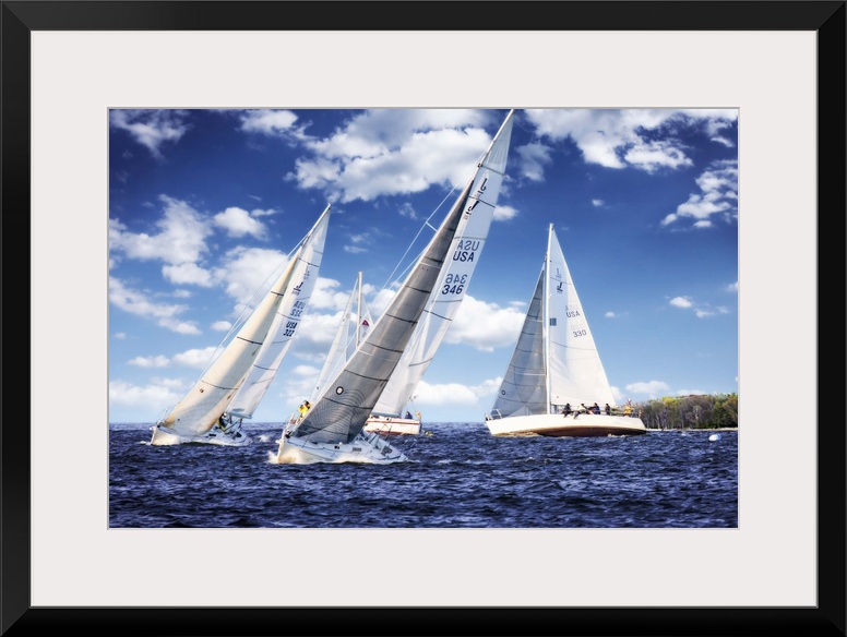 Three white sailboats on the water under a cloudy blue sky.