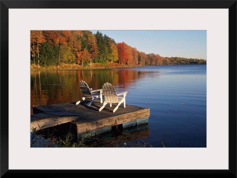 Adirondack Chairs On Dock At Lake