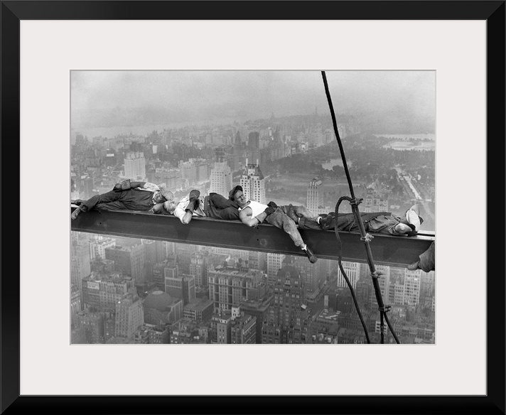 Four construction workers take a nap, balanced on a steel girder hung 800 feet over Manhattan, during the construction of ...