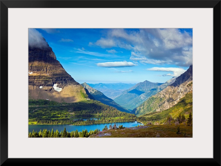 Large, landscape photograph of  Hidden Lake from an overlook, surrounded by mountains in Glacier National Park.