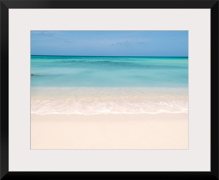 Horiztonal wall art of a serene beach and a still sea on a clear day in Aruba.