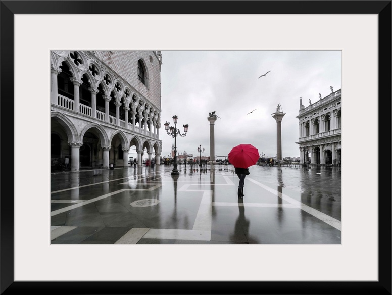 Italy, Veneto, Venice. Woman with red umbrella in front of Doges palace with acqua alta (MR)