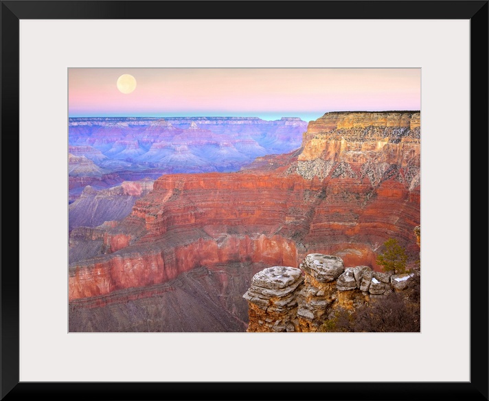 Amazing landscape photograph of the famous Southwest American canyon the captures a wide variety of colors and a full moon...