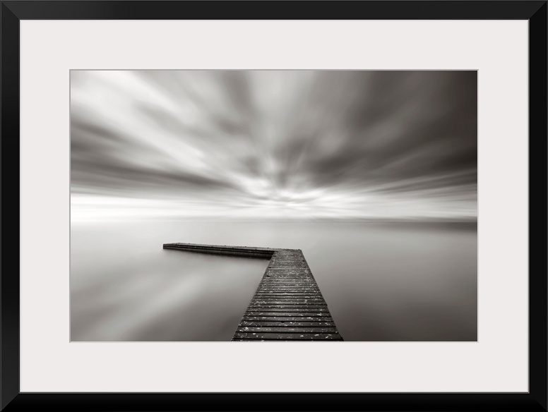 This wall art is a time lapsed photograph of this lake pier has created a sensation of motion in the sky and water which h...