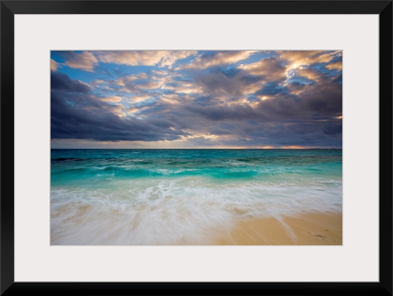 A giant photograph of a beach on the Ambergris Cay Island within the Turks and Caicos Islands.  The colorful ocean contras...