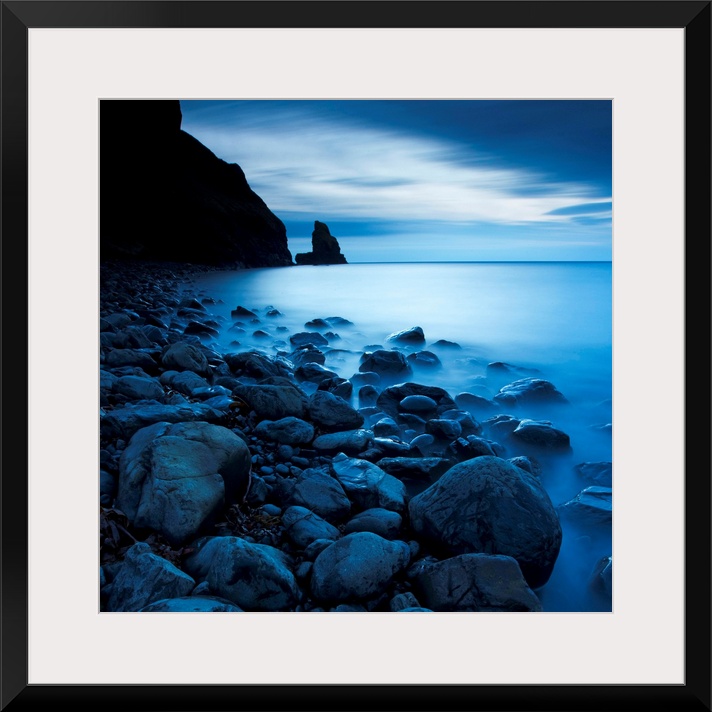 This is a vertical landscape photograph of fog and water on rocky beach that would make great huge wall art for the home o...