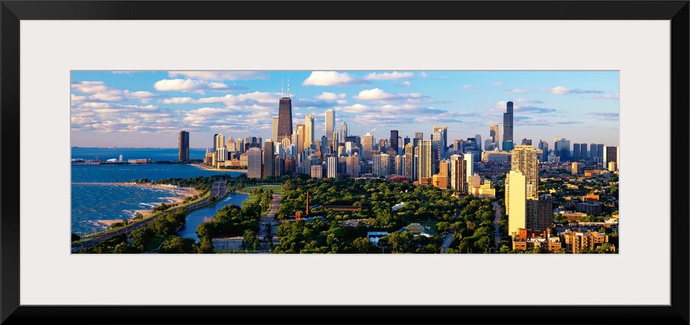 Panoramic photograph taken of the busy skyline of Chicago, Illinois on a sunny day.  The skyscrapers in the background are...