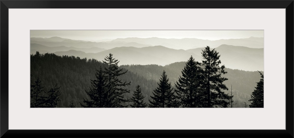 Panoramic monochromatic photograph displays a view overlooking the layered mountain ranges within a region of the Southeas...